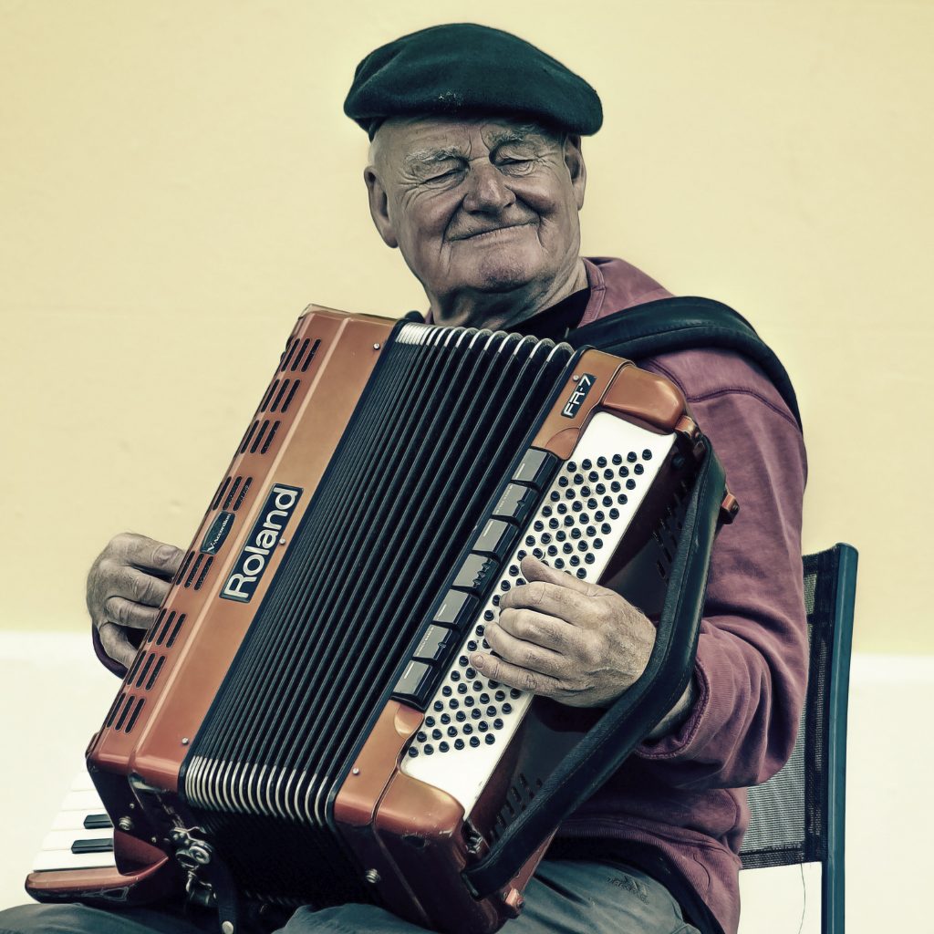 sitting accordian player wearing a beret